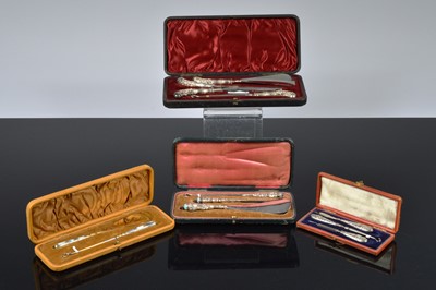 Lot 521 - Four cased dressing table sets