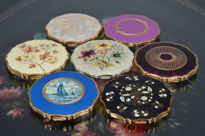 Lot 536 - Ten 1960s and later scalloped edged circular gilt metal, chromed and coloured enamel Stratton compacts