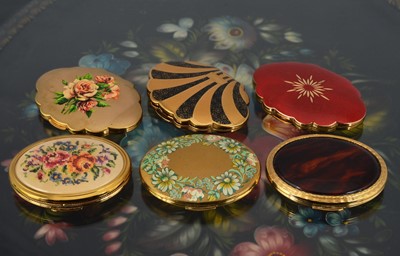 Lot 556 - Three oval gilt metal 1970s Kigu compacts
