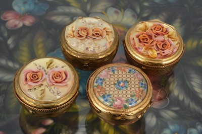 Lot 557 - Four 1950s gilt metal Kigu Bouquet basket compacts