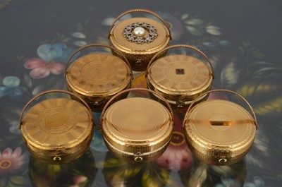 Lot 558 - Six 1950s gilt metal Kigu Bouquet basket compacts