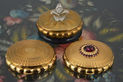Lot 563 - Three oval gilt metal 1970s Kigu cushion compacts