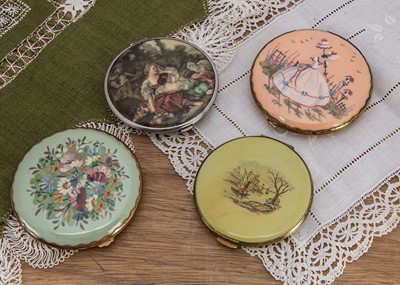 Lot 586 - Four circular compacts