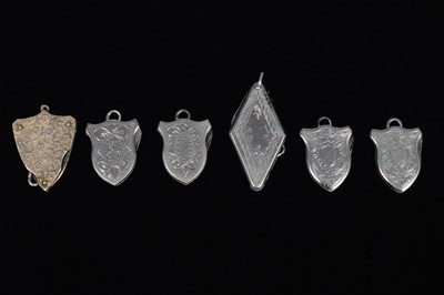 Lot 703 - A group of five Shield Shaped Button Hook/ Pocket Knives