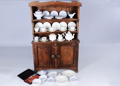 Lot 472 - A child's wooden dresser with tea set
