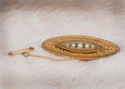 Lot 30 - A 15ct gold seed pearl and demantoid garnet oval brooch with box back