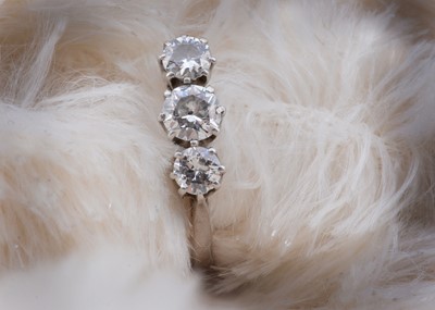 Lot 54 - A platinum three stone diamond dress ring