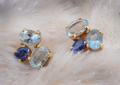 Lot 84 - A pair of sapphire and aqua cluster earrings