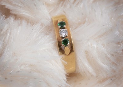 Lot 96 - A continental 14k marked diamond and emerald dress ring