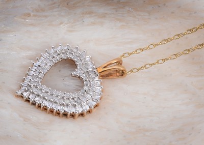 Lot 99 - A 9ct gold diamond encrusted heart shape pendant
