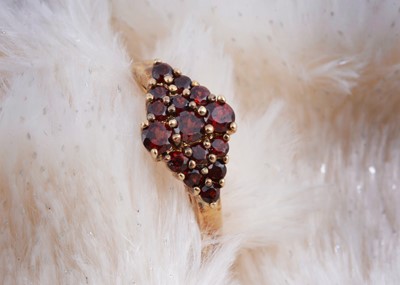 Lot 120 - A 9ct gold garnet dress ring