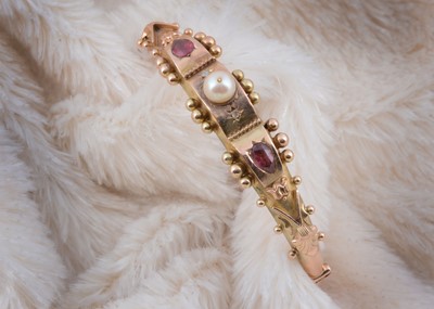 Lot 198 - A 9ct gold garnet, pearl and diamond bangle