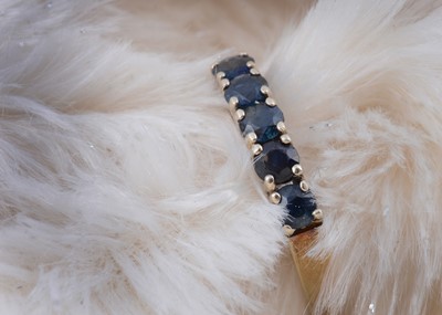 Lot 204 - A 14ct gold sapphire half hoop ring