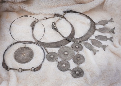 Lot 218 - Four Asian white metal torque necklaces
