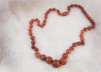 Lot 242 - A string of spherical graduated beads