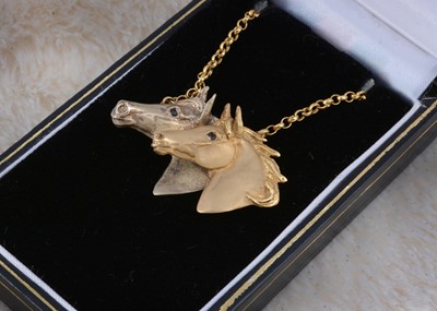 Lot 259 - A 9ct gold double horse head pendant and chain