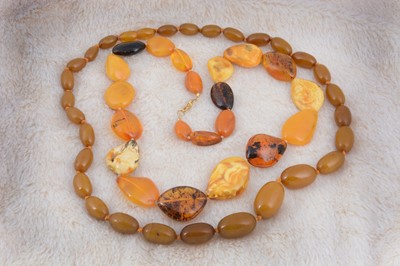 Lot 264 - A string of Baltic and desert amber graduated pebble necklace
