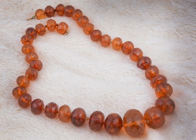 Lot 267 - A string of faceted graduated translucent amber beads