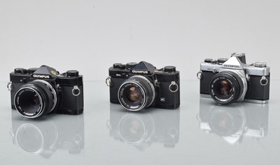 Lot 334 - Three Olympus OM SLR Cameras