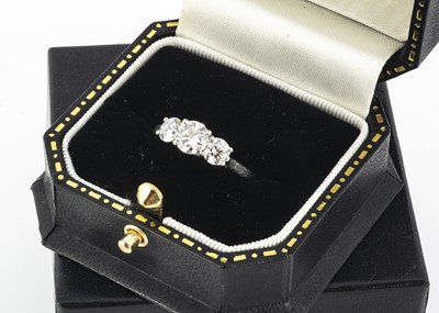 Lot 79 - A contemporary platinum three stone diamond ring