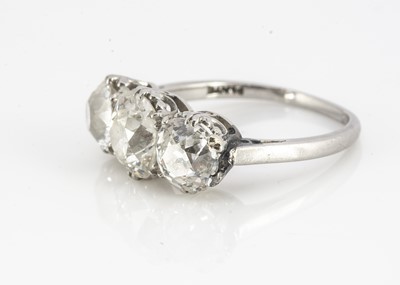 Lot 105 - A platinum diamond three stone old oval cut mounted dress ring