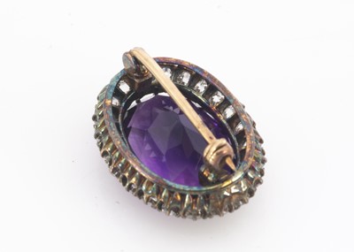 Lot 109 - An Edwardian amethyst and diamond oval cluster brooch