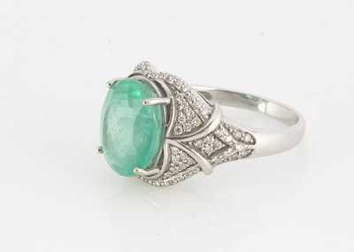 Lot 111 - A contemporary emerald and diamond dress ring
