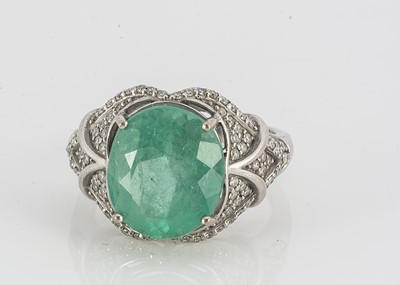 Lot 111 - A contemporary emerald and diamond dress ring