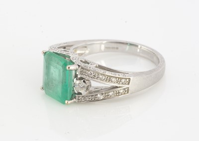 Lot 118 - A white 18ct gold emerald and diamond dress ring