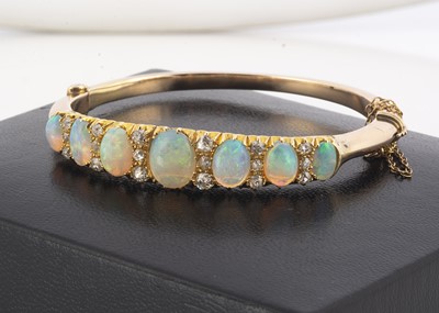 Lot 141 - An early 20th Century opal and diamond hinge bangle