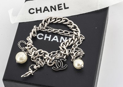 Lot 176 - A certificated Chanel white metal charm bracelet
