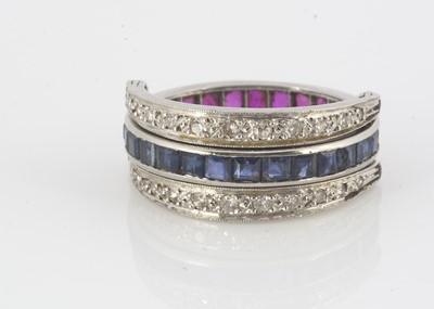Lot 210 - A white metal diamond, sapphire and ruby night and day ring
