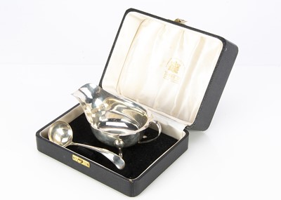 Lot 237 - A 1950s cased silver sauce boat and ladle from Viners