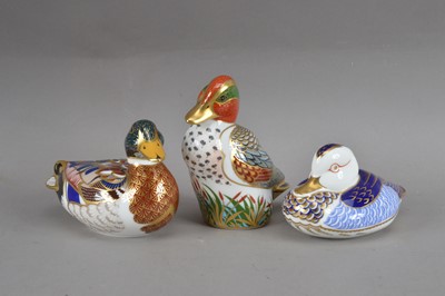 Lot 353 - Three Royal Crown Derby bone china duck paperweights