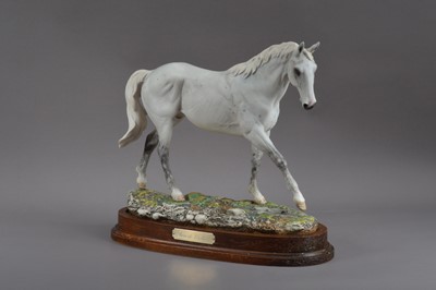 Lot 404 - A limited edition 'Desert Orchid' ceramic Royal Doulton horse, on a wooden base, no. 547/7500, marked to the underside, 31cm high
