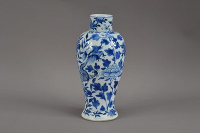 Lot 478 - A Chinese porcelain blue and white vase, floral decoration with two dragons, four character mark to the underside, 22cm high